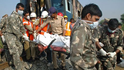 Indian rescuers carry away a victim of  the deadly train fire.