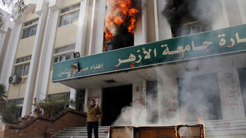 A man stands outside a faculty building at Cairo's Al-Azhar University after student supporters of the Muslim Brotherhood stormed it on December 28, 2013