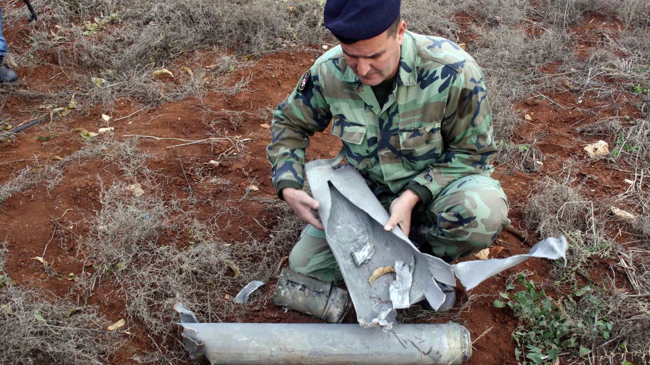 A Lebanese soldier examines of one 20 the shells that were fired by the Israeli army into southern Lebanon on December 29, 2013.