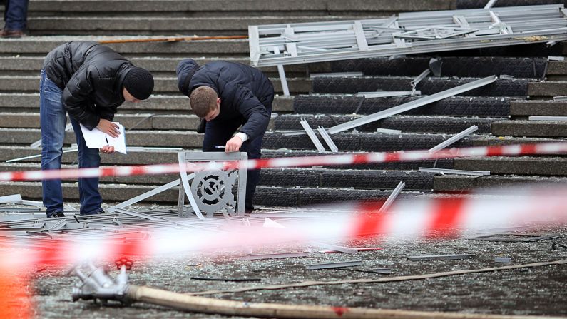 Police investigators inspect debris at the scene of the explosion.