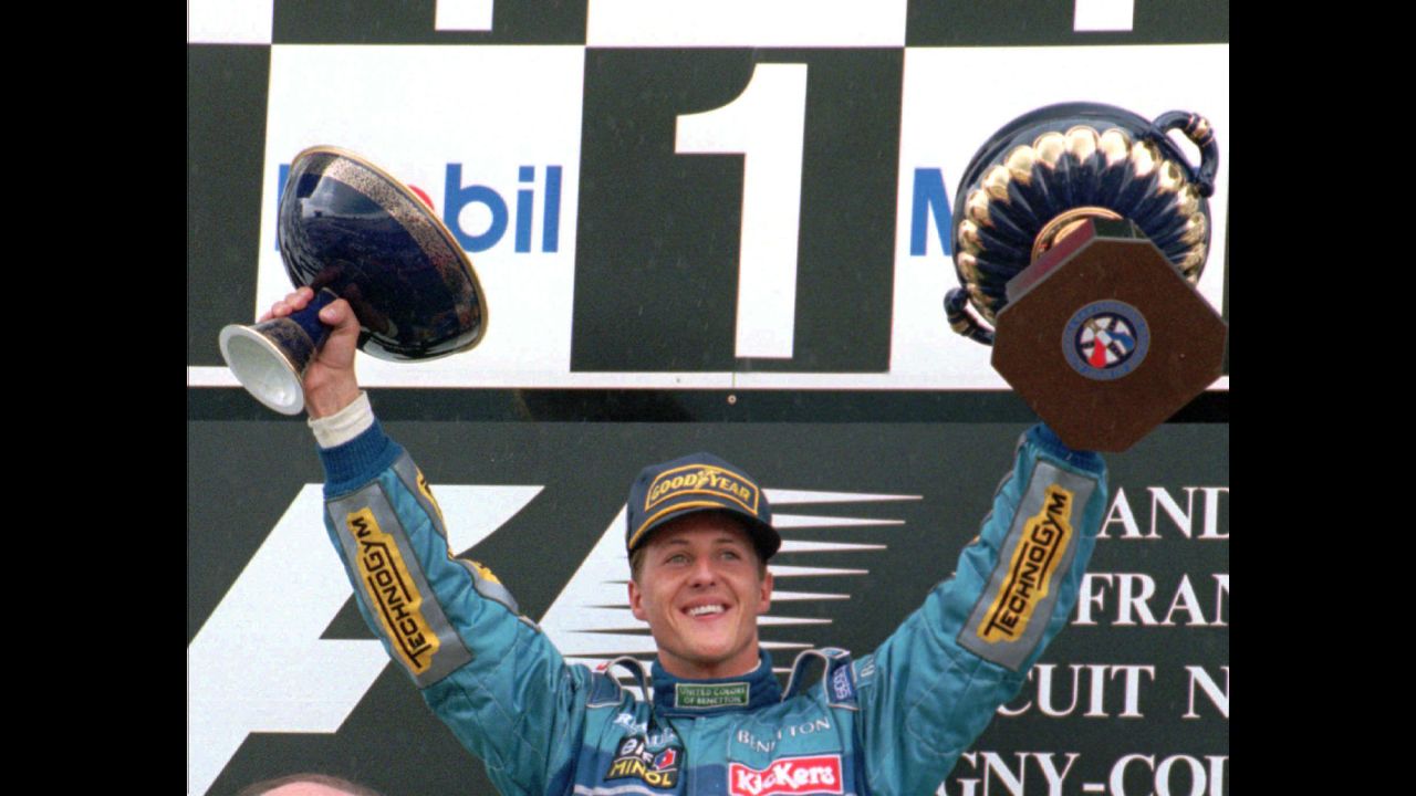 Schumacher holds up the victory trophy, left, and the French Republic President's trophy after winning the French Formula 1 Grand Prix in Magny Cours, France, in 1995.