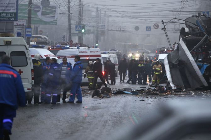 Experts, firefighters and police officers examine the scene of the blast.