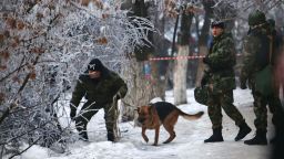 Police officers with a sniffing dog examine territory around the site of a trolleybus explosion in Volgograd, Russia on Monday December 30.