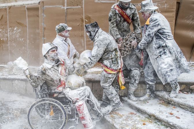 The flour and military outfits create scenes reminiscent of famous historical battles.
