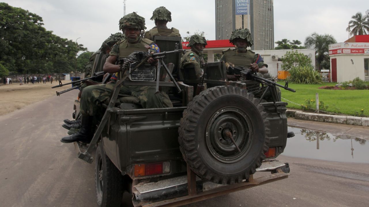 Soldiers of the Democratic Republic of Congo Army patrol in a vehicle after gunfire erupted on December 30 in the capital.