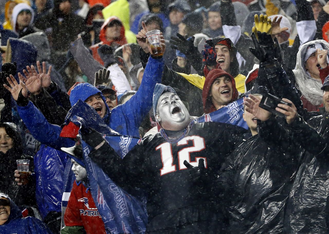 <strong>December 29: </strong>Rain-soaked New England Patriots fans cheer during the third quarter of an NFL football game between the Patriots and the Buffalo Bills.