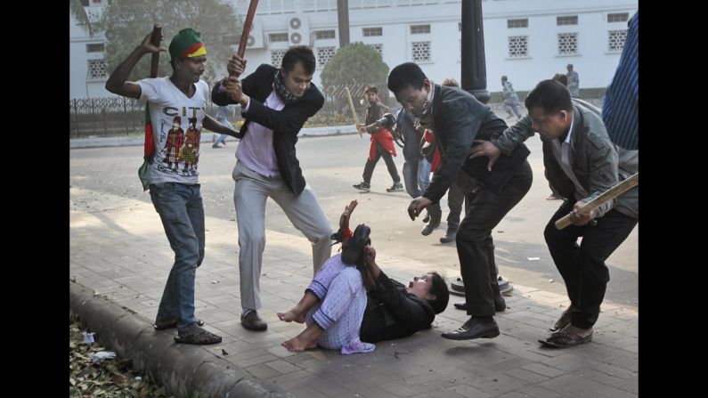 <strong>December 29: </strong>Supporters of the ruling Bangladesh Awami League beat a lawmaker and supporter of the main opposition Bangladesh Nationalist Party during a protest in Dhaka, Bangladesh.