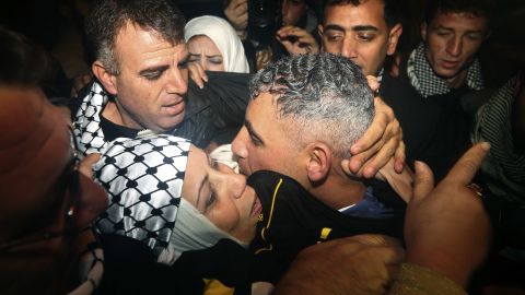 Rami Barbakh, a released Palestinian prisoner, center, is reunited with his mother in the northern Gaza town of Beit Hanoun.