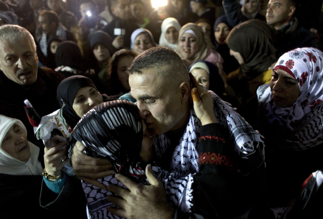DECEMBER 31 - RAMALLAH, WEST BANK: A released Palestinian prisoner is embraced by his family, after <a href="http://cnn.com/2013/12/30/world/meast/israel-palestinian-prisoner-release/index.html?hpt=imi_c1">Israel freed 26 prisoners in a gesture of goodwill between the two sides</a>. The release was a step aimed at "resuming the diplomatic process," Israeli Prime Minister Benjamin Netanyahu's office said. Many of the prisoners have served sentences of 19-28 years for deadly attacks against Israelis.