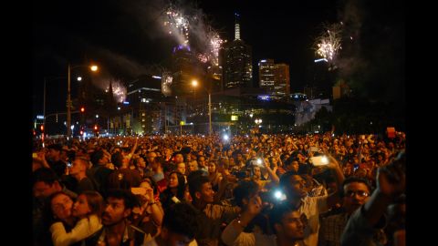 A crowd watches the New Year's fireworks in Melbourne.