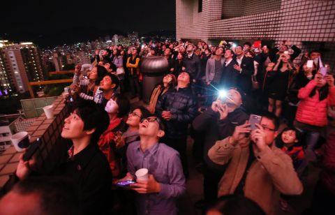 People watch a fireworks display during celebrations in Taipei, Taiwan.