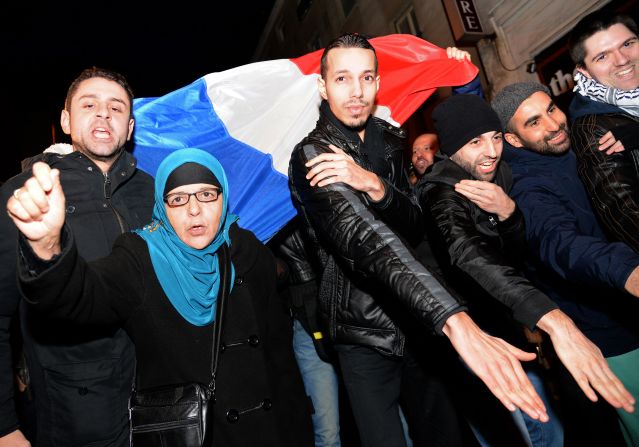 The "quenelle" gesture has been popularized by the anti-establishment French comedian Dieudonne, who has been condemned in France for anti-Semitism. Here people perform the "quenelle" in front of  Dieudonne's theater, while protesting against French interior minister Manuel Valls who has called for Dieudonne's performances to be banned. 