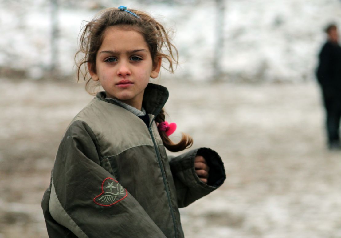 A Syrian girl plays in the city of Aleppo, bombed two days after this photo was taken on December 13.