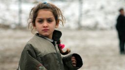 A Syrian girl plays in the snow in the Syrian city of Aleppo, which was bombed two days after this photo was taken on December 13.