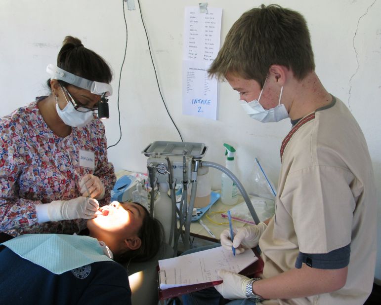 Nelson Broussard, right, assists dentist Darshini Khosla in Leh, India, as part of a volunteer team providing dental care for poor kids.