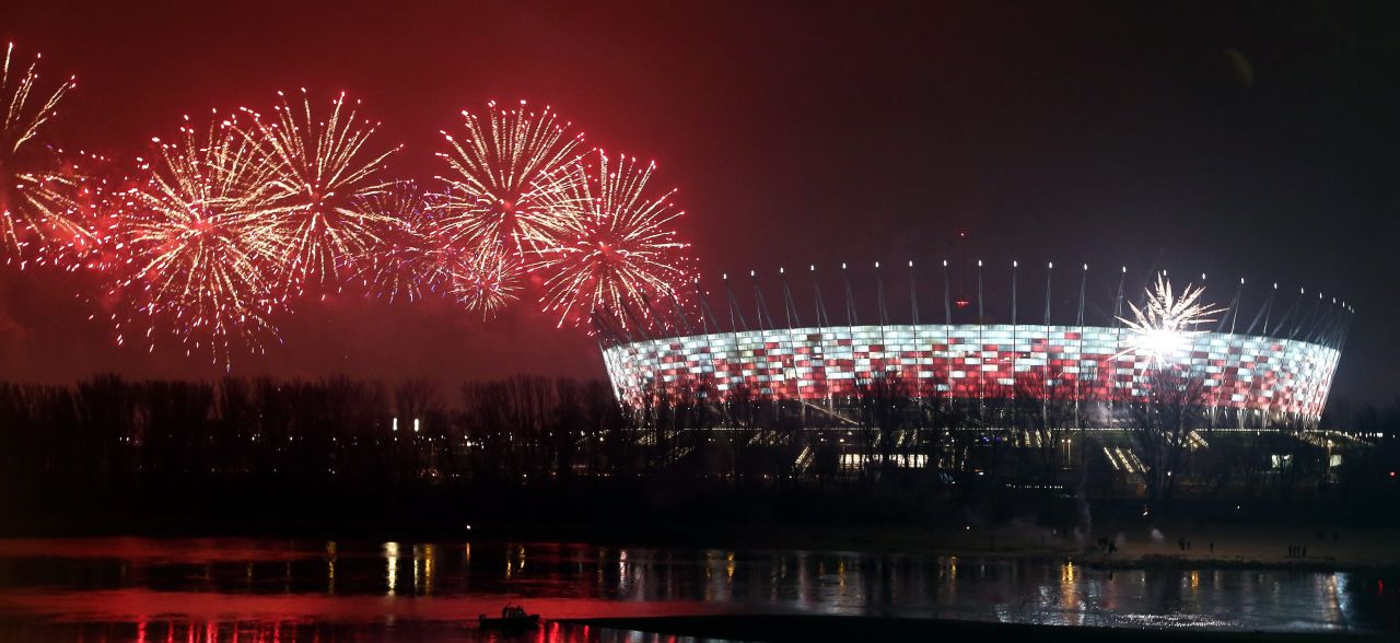 Fireworks welcome the new year over the National Stadium and the Vistula River in Warsaw, Poland.