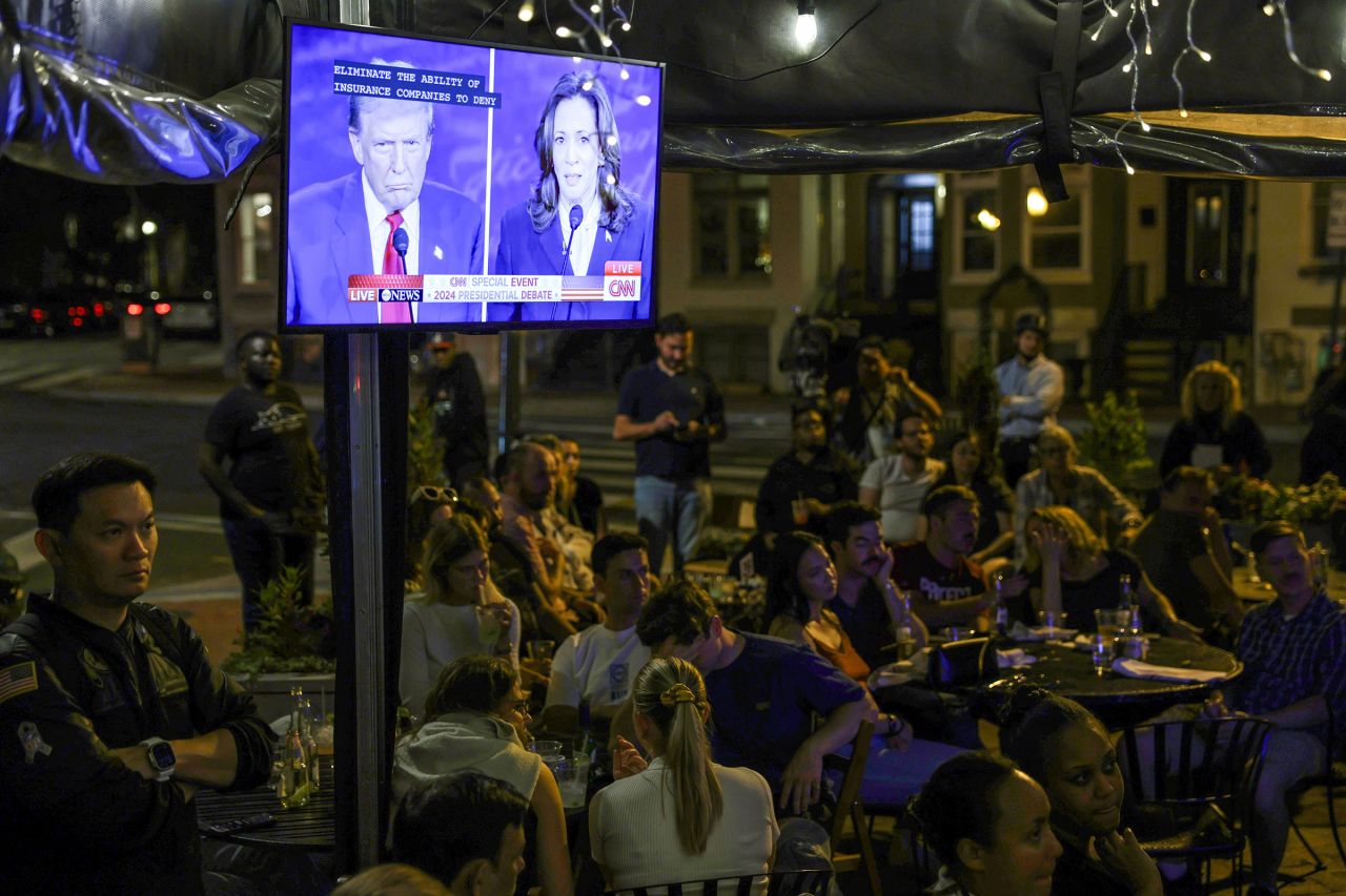 People watch the presidential debate during a debate watch party at Shaw’s Tavern on September 10 in Washington, DC. 