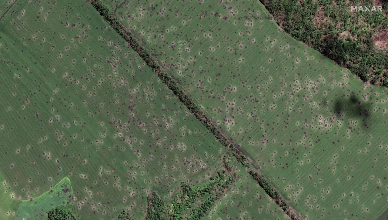 Craters from artillery strikes dot a field outside the village of Dovhenke.