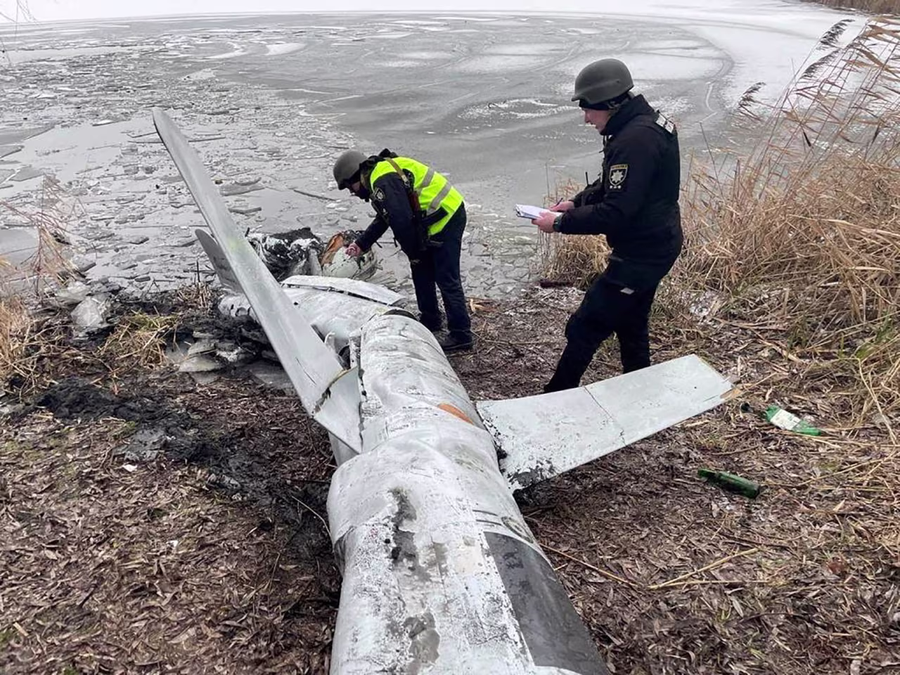 Police officers inspect a Russian cruise missile shot down by the Ukrainian Air Defence Forces in Kyiv, Ukraine, on January 26.