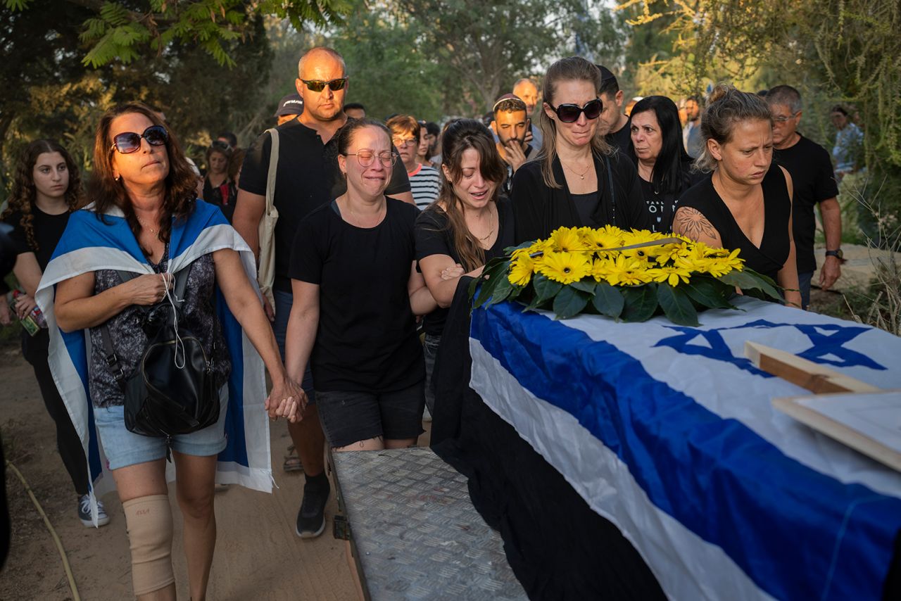 Relatives attend the funeral of Albert Miles, 81, at the Kibbutz Revivim cemetery, southern Israel, on October 30. Miles was killed during the Hamas attack on October 7, in kibbutz Be'eri near the border with Gaza. 