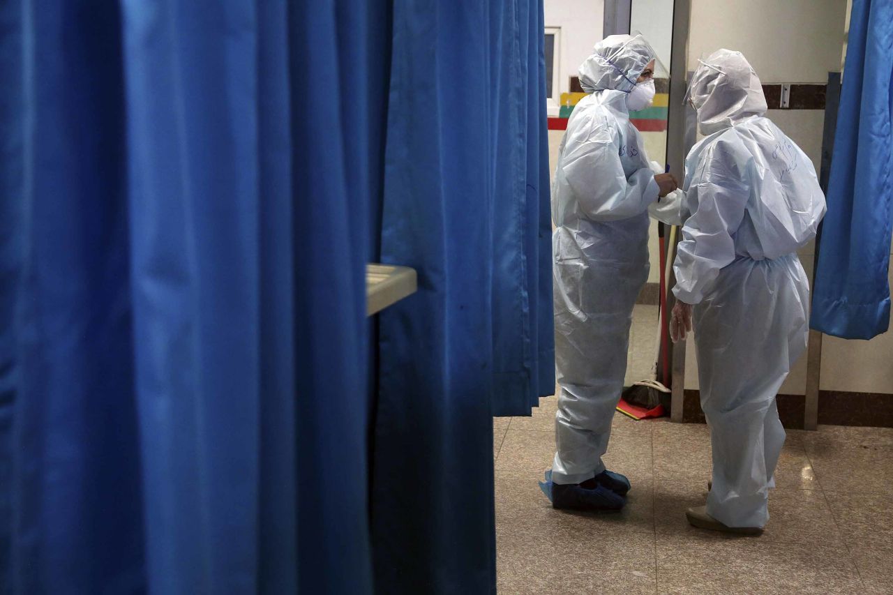 Medical workers talk in a hospital ward for coronavirus patients in Tehran, Iran, on March 8.