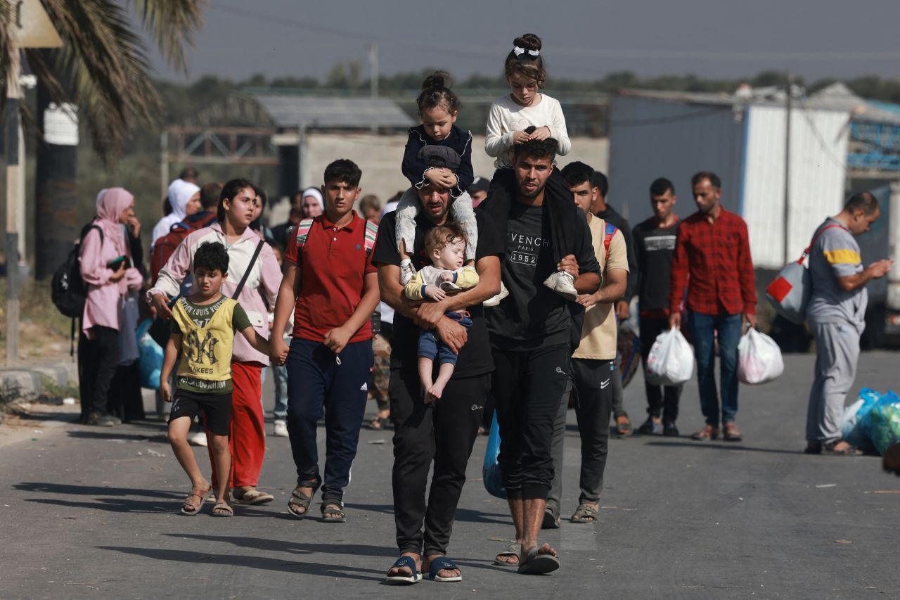 Palestinians walk down a road as they flee Gaza City and other parts of northern Gaza towards the south, on November 8.