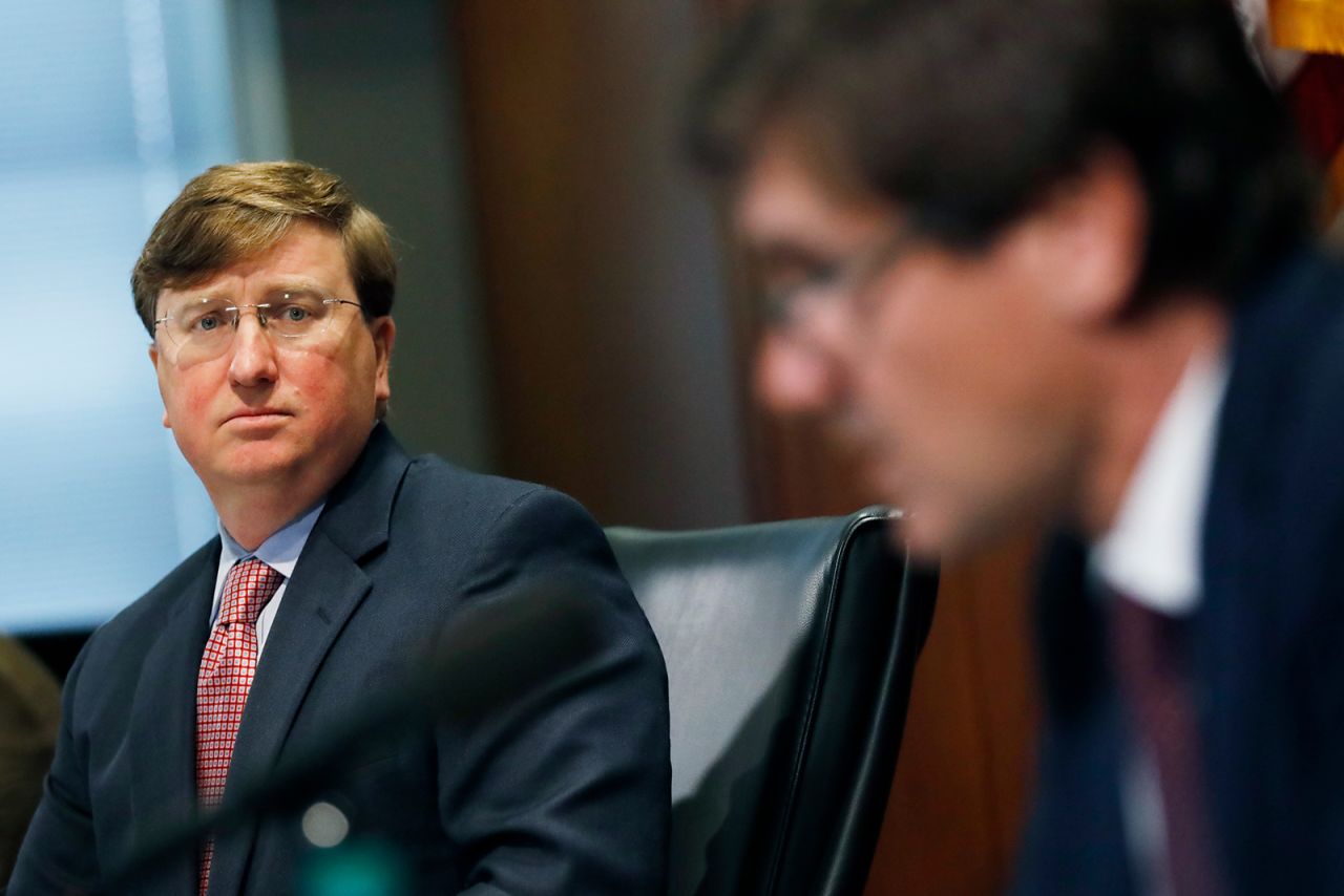 Mississippi Gov. Tate Reeves, left, listens as State Health Officer Dr. Thomas Dobbs, discusses the state's efforts to reduce and limit transmission from the COVID-19 virus, Monday, July 20, during a press briefing in Jackson.
