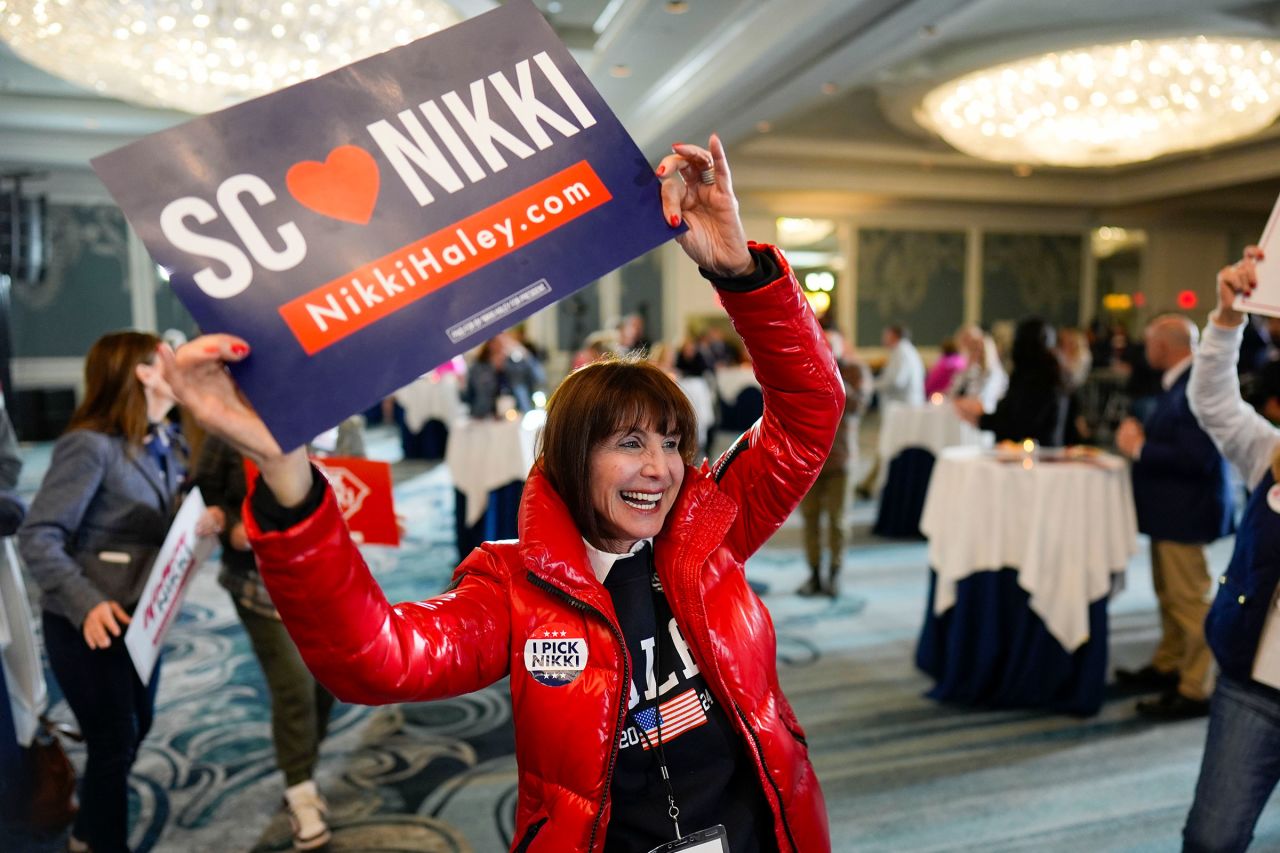 A supporter of Republican presidential candidate Nikki Haley holds up a campaign sign while waiting for the results of the South Carolina presidential primary on Saturday, February 24, in Charleston. 