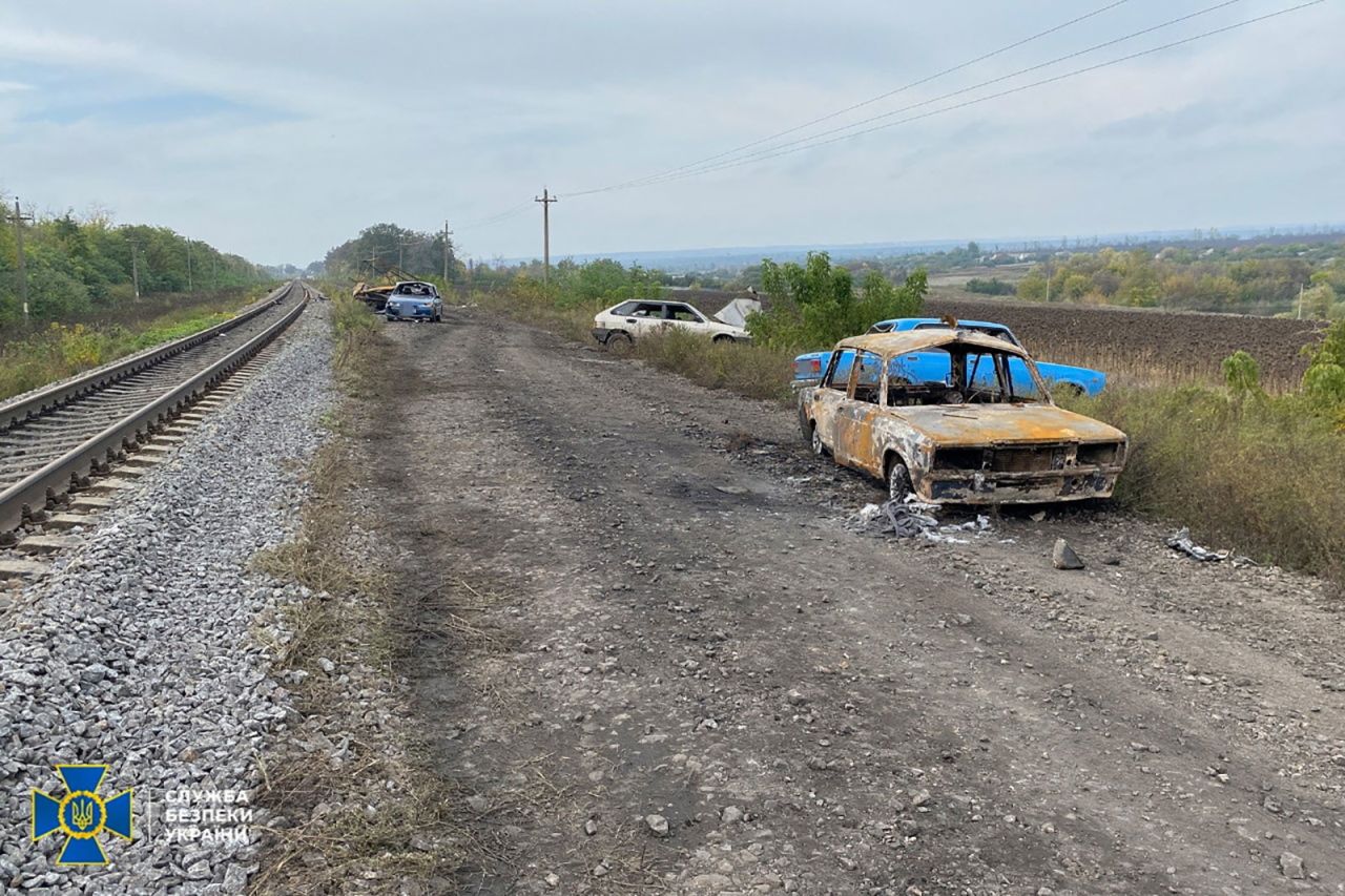 Cars from a civilian convoy sit on the side of the road after Russian shelling in Kupiansk, Ukraine, in this photo released on October 1. 