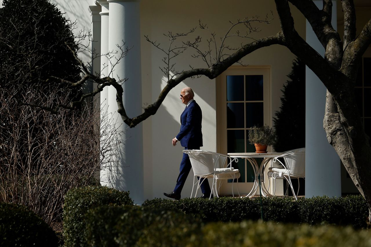 President Joe Biden walks along the Rose Garden colonnade before departing the White House in February.