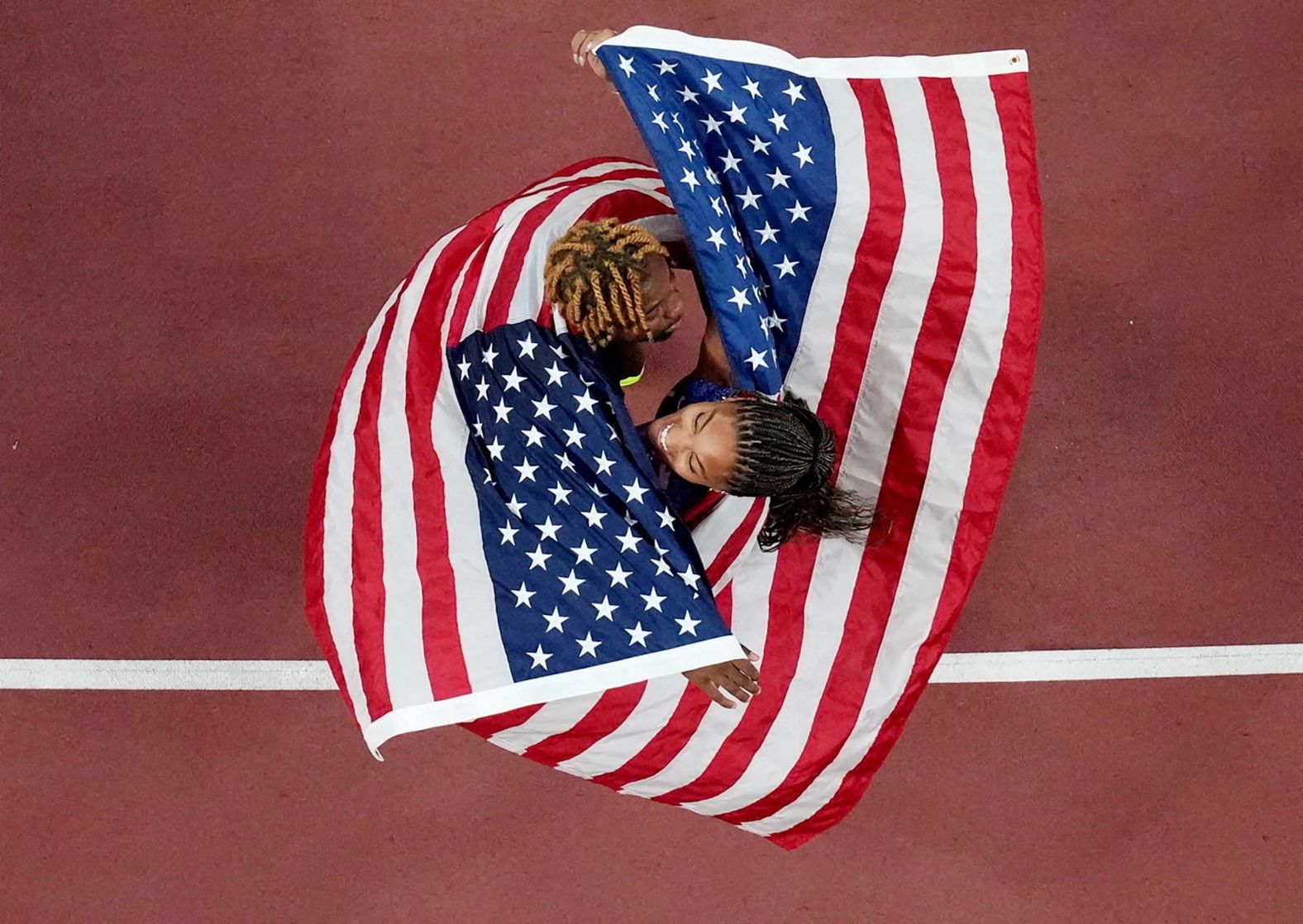 American track stars Noah Lyles, left, and Tara Davis-Woodhall celebrate together at the World Athletics Championships in Tokyo on Sunday, September 14. Lyles won bronze in the 100 meters. Davis-Woodhall won gold in the long jump.