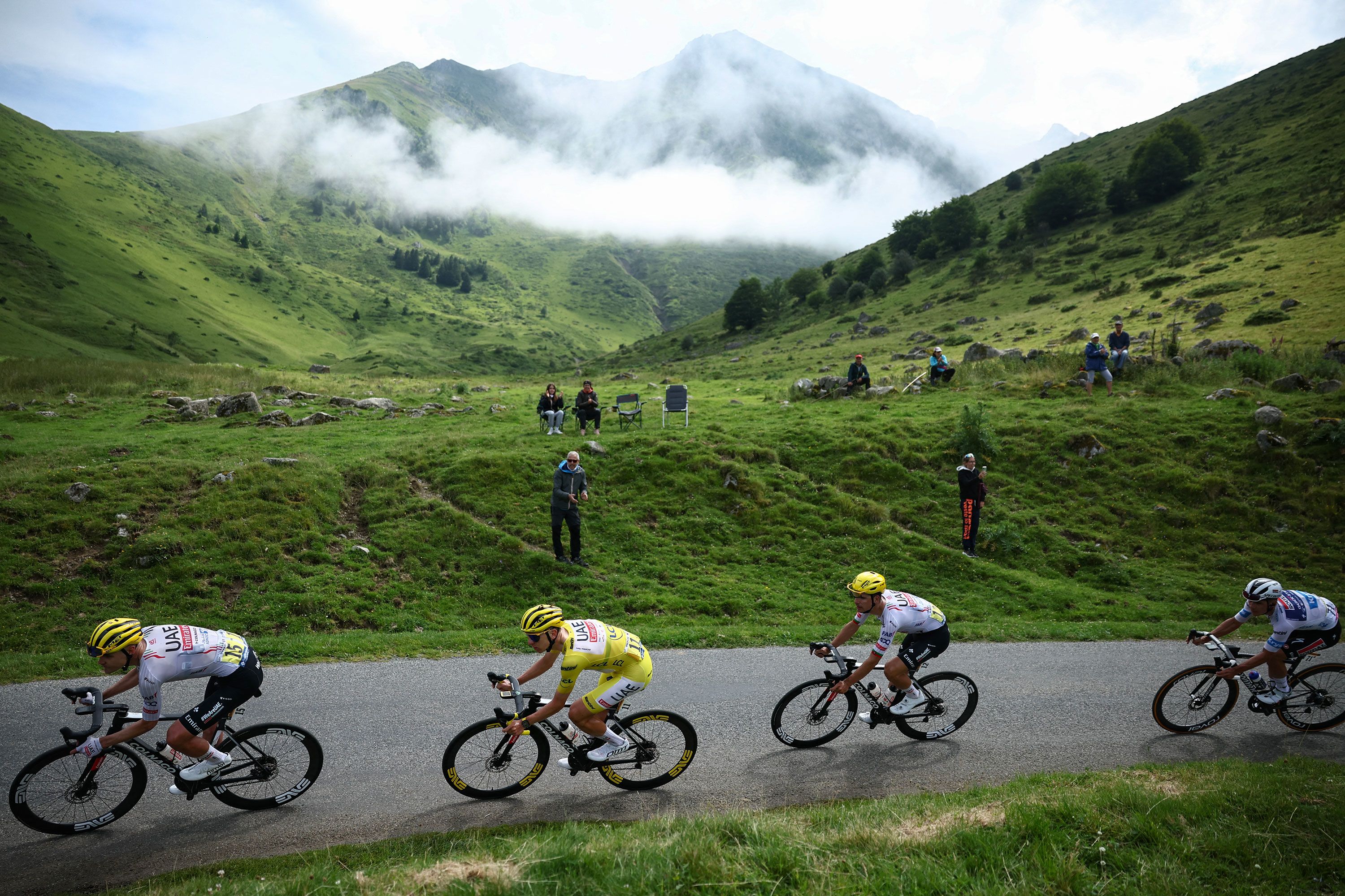 Slovenian cyclist Tadej Pogačar, wearing the overall leader's yellow jersey, races during the 14th stage of the Tour de France on Saturday, July 13. Pogačar won the stage, which took place between Pau and Saint-Lary-Soulan in the Pyrenees mountains.