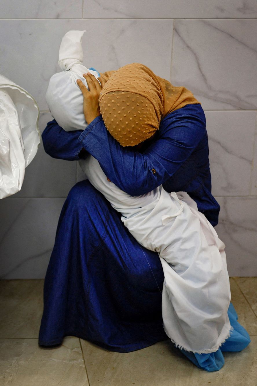 Inas Abu Maamar embraces the body of her 5-year-old niece, Saly, at the Nasser Hospital morgue in Khan Younis, Gaza, on October 17. <a href="https://www.reuters.com/investigates/special-report/israel-palestinians-gaza-woman/" target="_blank">Saly was killed in an Israeli strike</a>, according to the Reuters news agency. Saly’s mother and sister were also killed, along with Inas’ uncle and aunt. “It was a powerful and a sad moment and I felt the picture sums up the broader sense of what was happening in the Gaza Strip,” photographer Mohammed Salem said. “People were confused, running from one place to another, anxious to know the fate of their loved ones, and this woman caught my eye as she was holding the body of the little girl and refused to let go.” The photograph was part of Reuters’ <a href="https://www.pulitzer.org/winners/photography-staff-reuters-3" target="_blank">Pulitzer Prize-winning package</a>.