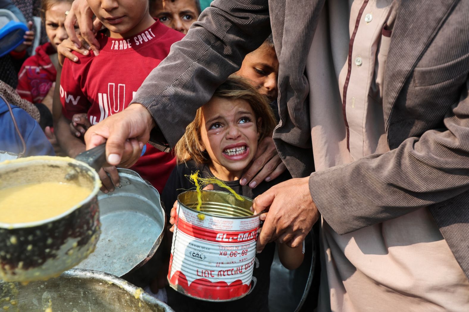 A child reacts as Palestinians gather to receive meals cooked by a charity kitchen in Deir al-Balah, Gaza, on Sunday, November 10. Civilians fleeing northern Gaza after weeks of intense Israeli military operations tell of a <a href="index.php?page=&url=https%3A%2F%2Fwww.cnn.com%2F2024%2F11%2F13%2Feurope%2Fus-israel-aid-gaza-insufficient-intl%2Findex.html">chronic lack of food and people dying of hunger</a>. Aid agencies warn that the area is on the brink of famine.