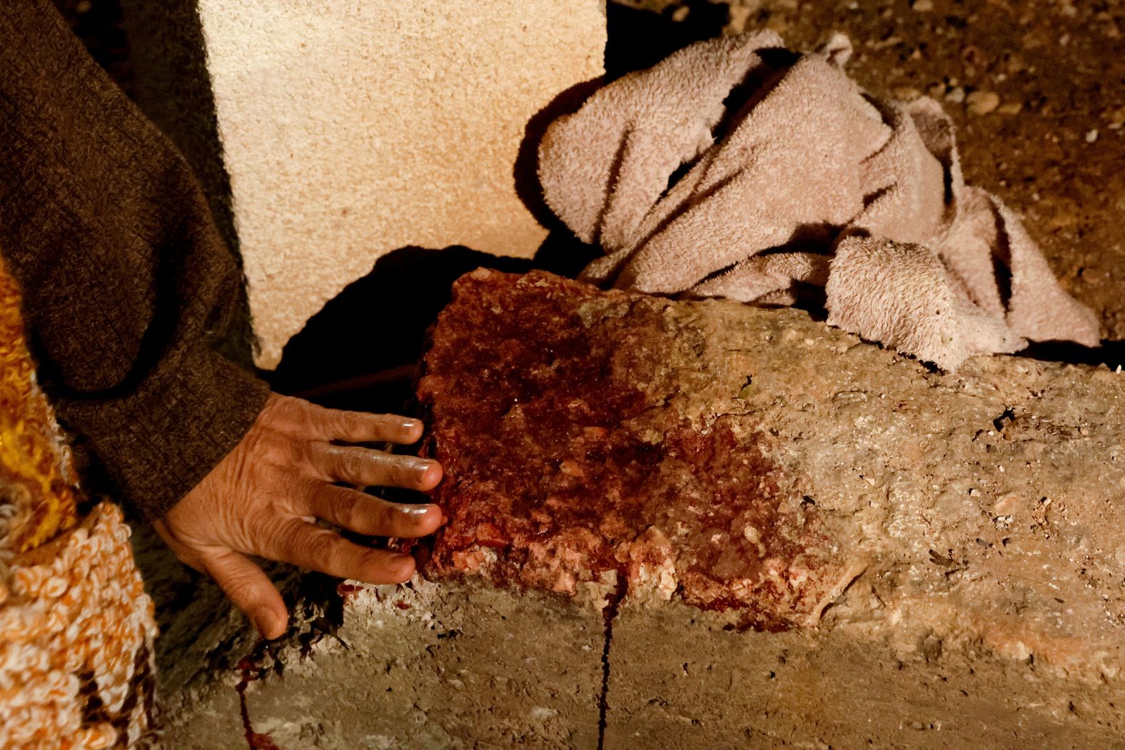 The mother of Adam Bisharat, a Palestinian killed in an Israeli drone strike, touches a blood stain at the site of the strike in Tammoun, West Bank, on Wednesday, January 8. While tensions have been rising in the West Bank for years, the October 7 attacks by Hamas and the subsequent Israeli assault on Gaza has ushered in a <a href="index.php?page=&url=https%3A%2F%2Fwww.cnn.com%2F2025%2F01%2F06%2Fmiddleeast%2Fwest-bank-shooting-israel-intl-latam%2Findex.html">volatile new chapter</a> in the occupied territory.