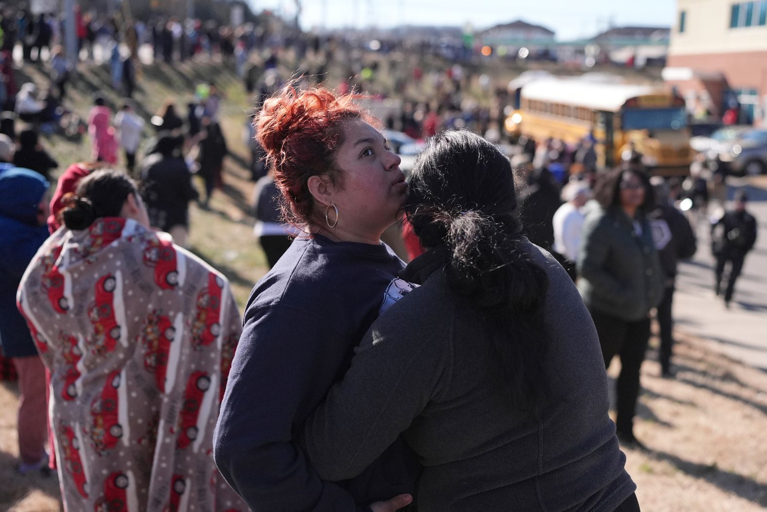 Families wait for school buses to arrive after there was a shooting at a high school in Nashville, Tennessee, on Wednesday, January 22. Police say 17-year-old Solomon Henderson <a href="index.php?page=&url=https%3A%2F%2Fwww.cnn.com%2F2025%2F01%2F22%2Fus%2Fantioch-high-school-shooting-nashville%2Findex.html">fired multiple rounds inside a cafeteria</a>, killing 16-year-old Josselin Corea Escalante before killing himself.