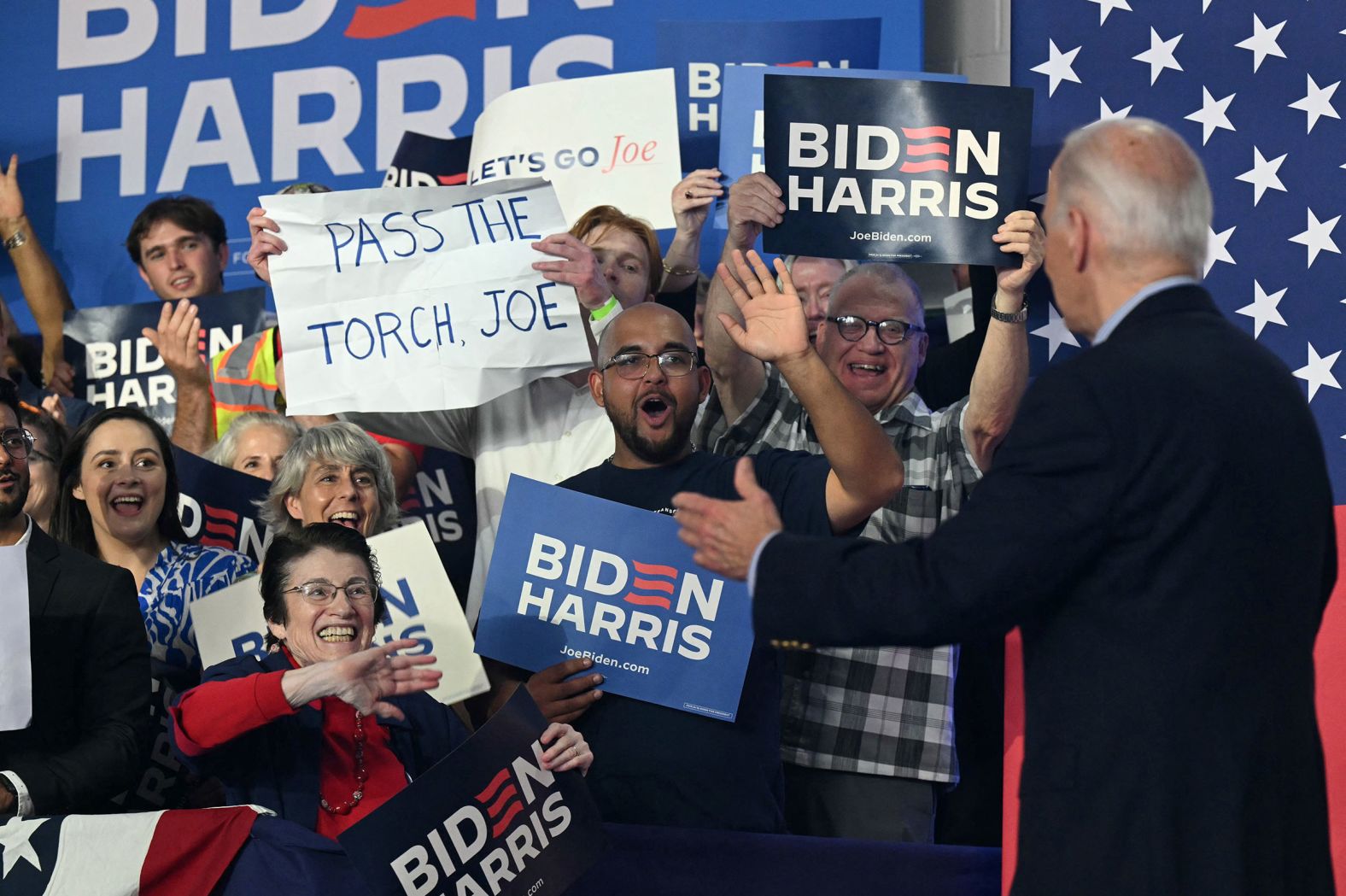 A sign reading “Pass the torch, Joe” is held up at a campaign rally for Biden in Madison, Wisconsin, on July 5.