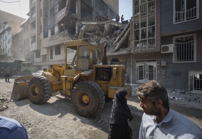 A loader works at the scene of a destroyed residential building in Tehran on Friday.