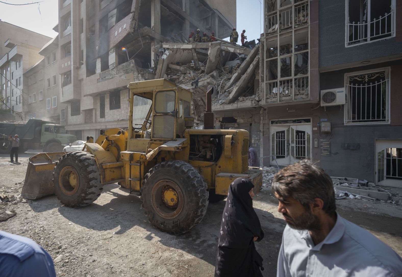 A loader works at the scene of a destroyed residential building in Tehran on Friday.