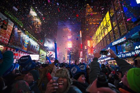 Revelers cheer under falling confetti at the stroke of midnight during New Year's Eve celebrations in Times Square, New York City, just after midnight on January 1.