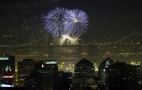 Fireworks fill the air over the San Francisco skyline, near the San Francisco Oakland Bay Bridge, as part of New Year's Eve celebrations just after midnight on Wednesday, January 1. Click through to see other New Year's celebrations around the world: