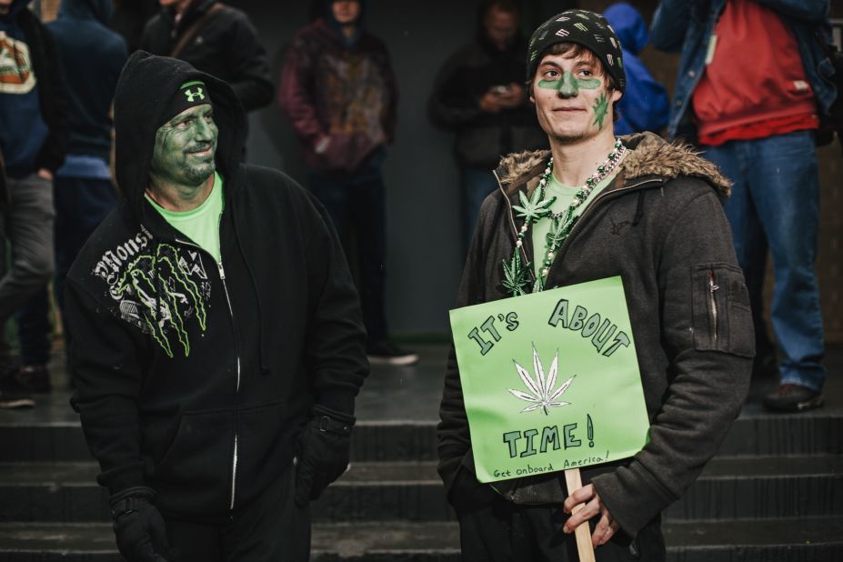 Darren Austin, left, and his son Tyler line up outside the 3D Cannabis Center.