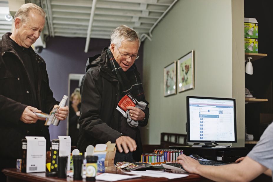 Mark Wootten, left, and Tom McCoy purchase marijuana products at the LoDo Wellness Center.