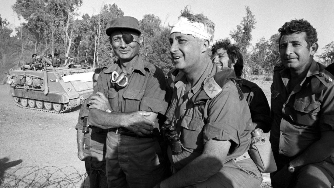 Defense Minister Moshe Dayan (left) visits with a bandaged Sharon during the Yom Kippur War in October 1973 on the western bank of the Suez Canal in Egypt. Sharon said  his greatest military success came during that war. He surrounded Egypt's Third Army and, defying orders, led 200 tanks and 5,000 men over the Suez Canal, a turning point.