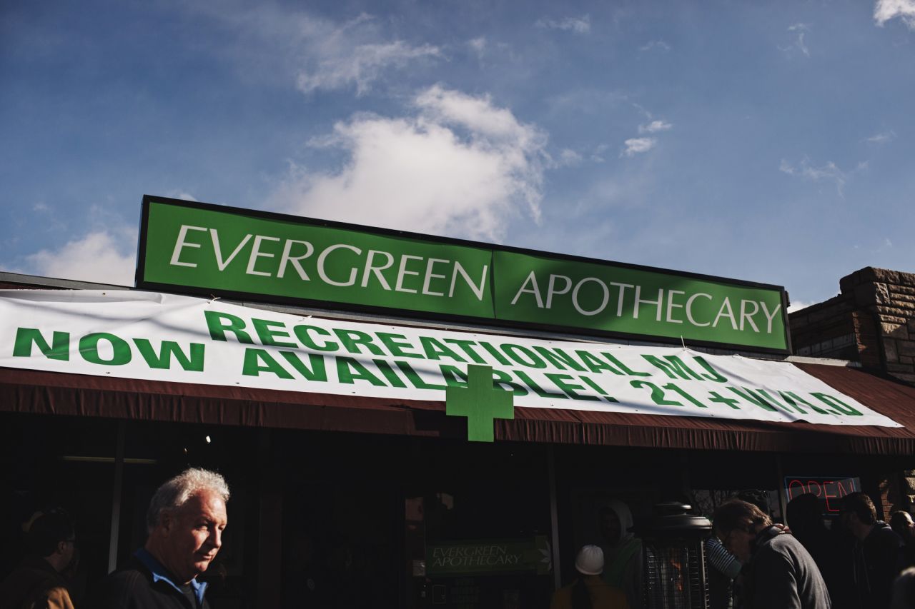 People line up to buy recreational marijuana outside of Evergreen Apothecary.