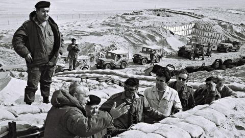 Former Prime Minister David Ben-Gurion is briefed in 1971 by Sharon in a trench near the Suez Canal in the Sinai.<br />
