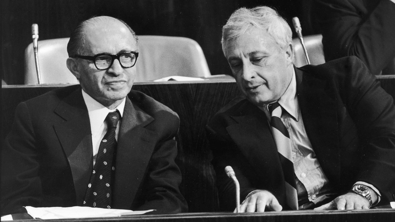 Sharon transitioned into government, including stints as military adviser, agriculture minister and defense minister. Here, he and Prime Minister Menachem Begin attend a Knesset meeting in June 1977.