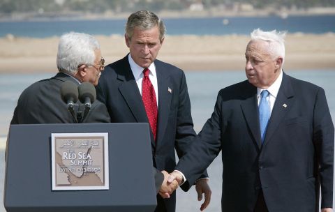 In June 2003, Sharon, right, met with Palestinian Authority leader Mahmoud Abbas, left, and U.S. President George W. Bush to discuss a Middle East "road map" for peace. After the meeting, Sharon expressed his "strong support" for a two-state solution to the Israeli-Palestinian conflict.