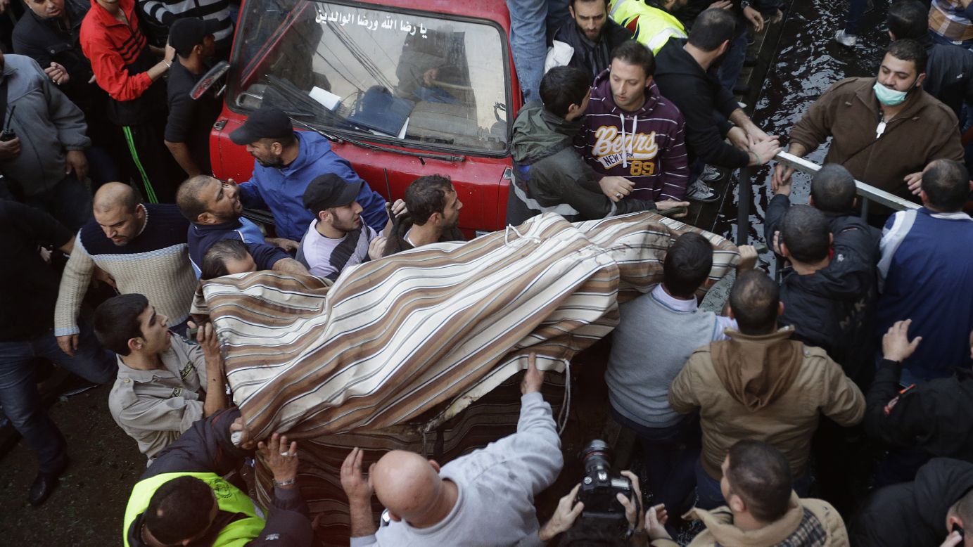 People carry a covered body from the site of the explosion.