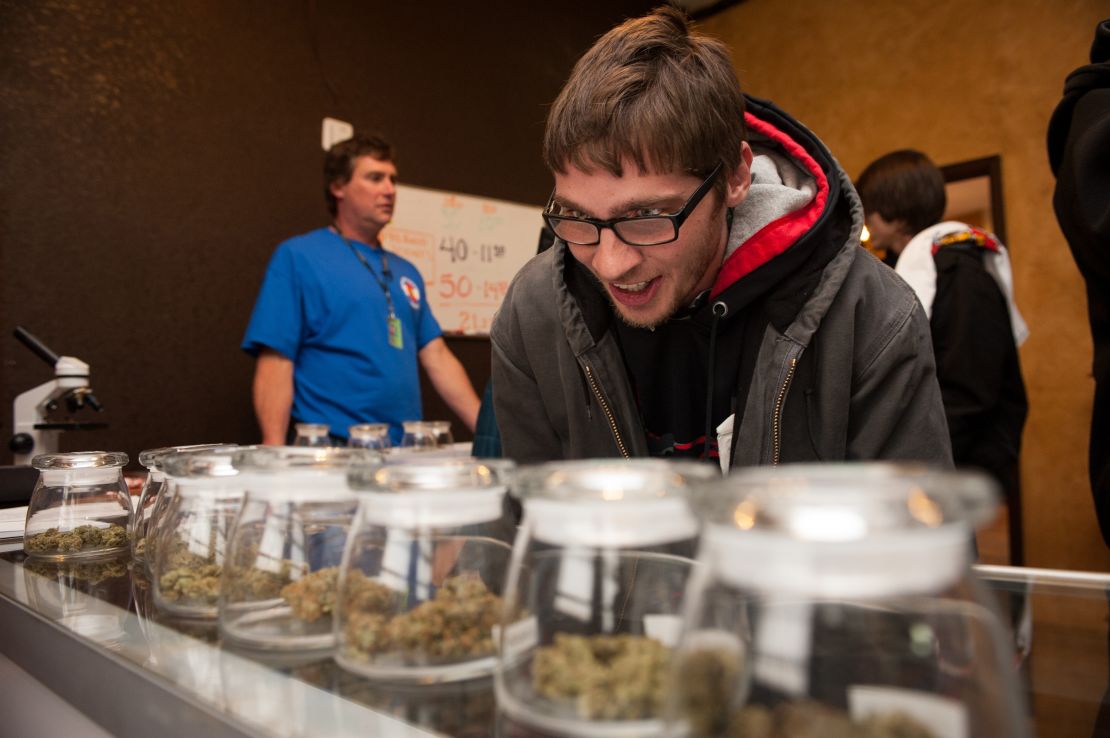Tyler Williams of Blanchester, Ohio, looks over marijuana strains at the 3-D cannabis dispensary on January 1 in Denver, Colorado.
